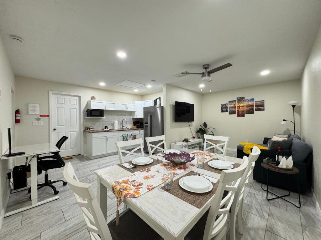 a dining room and kitchen with a table and chairs at Sunshine Nest in Lehigh Acres