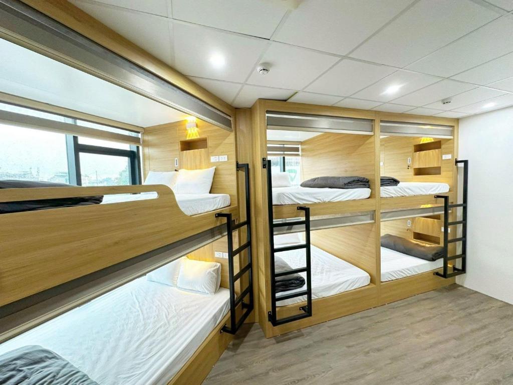 a room with three bunk beds in a boat at Ha Noi Capsule Station Hostel in Hanoi