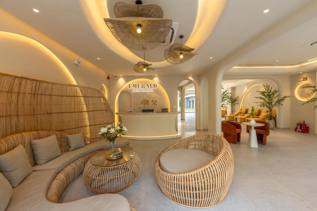 a lobby with a couch and chairs and a table at Emerald Boutique Hotel Phú Quốc in Phú Quốc