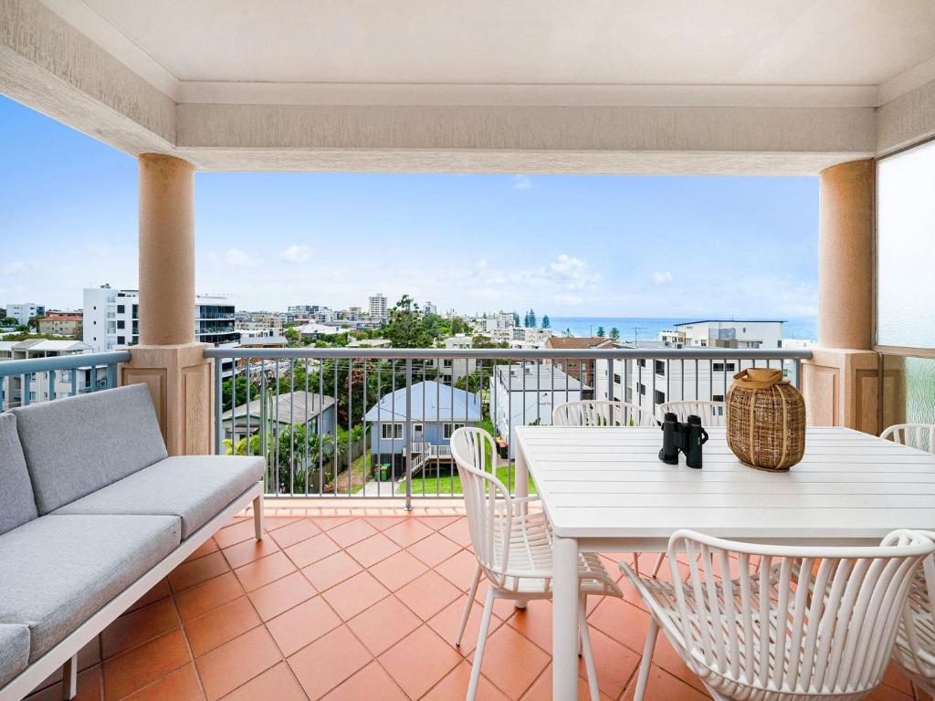 a balcony with a white table and chairs at Seabreeze unit 5, Kings Beach in Caloundra