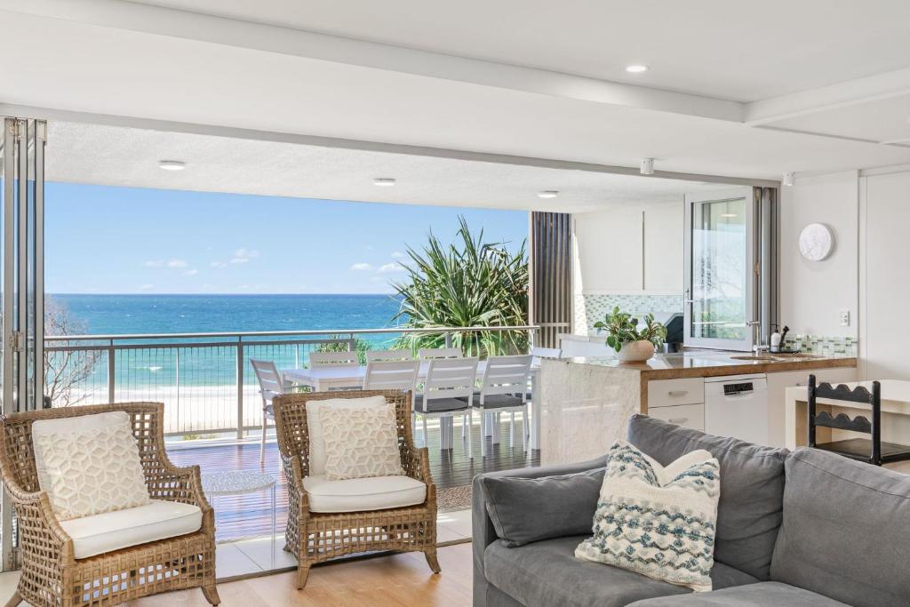 a kitchen and living room with a view of the ocean at Waves #9 by Discover Stradbroke in Point Lookout
