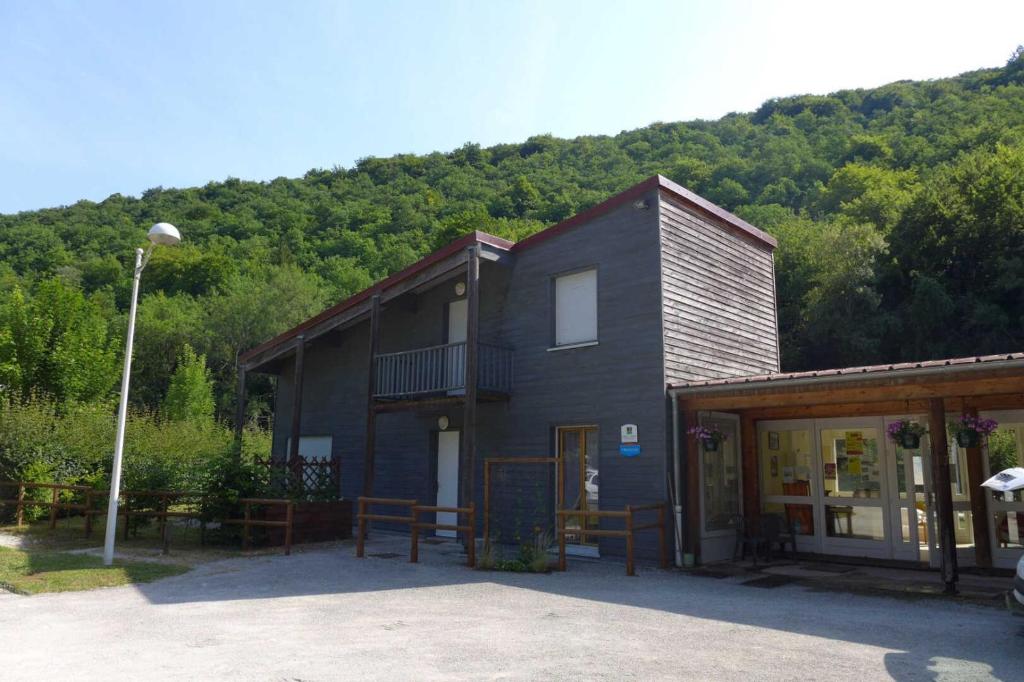 a black building with a mountain in the background at Valériane in Froncles