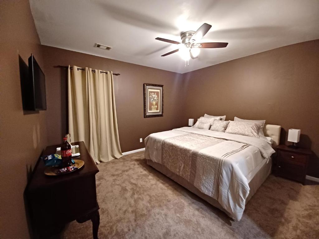 a bedroom with a bed and a ceiling fan at Nice Luxury Suite in Austell
