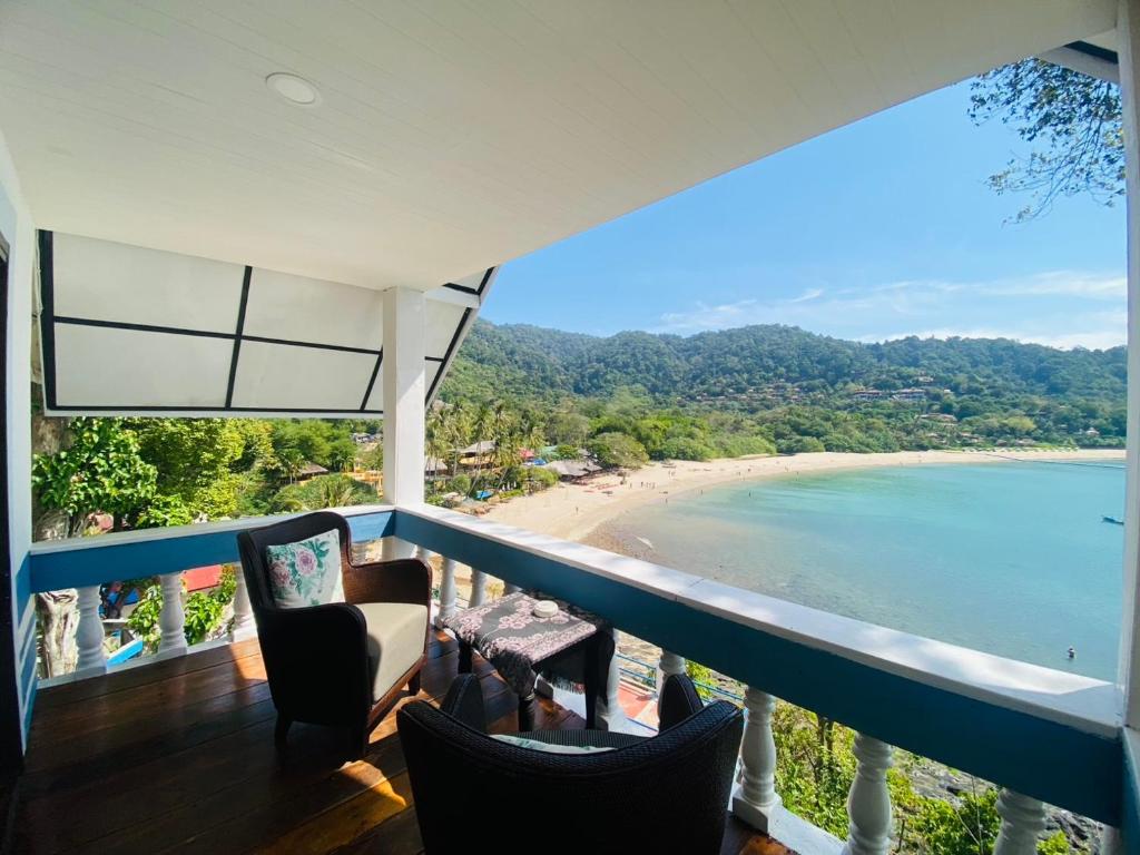 a balcony with chairs and a view of a beach at Paradise view A5 -Kantiang paradise resort- in Ko Bu Bu