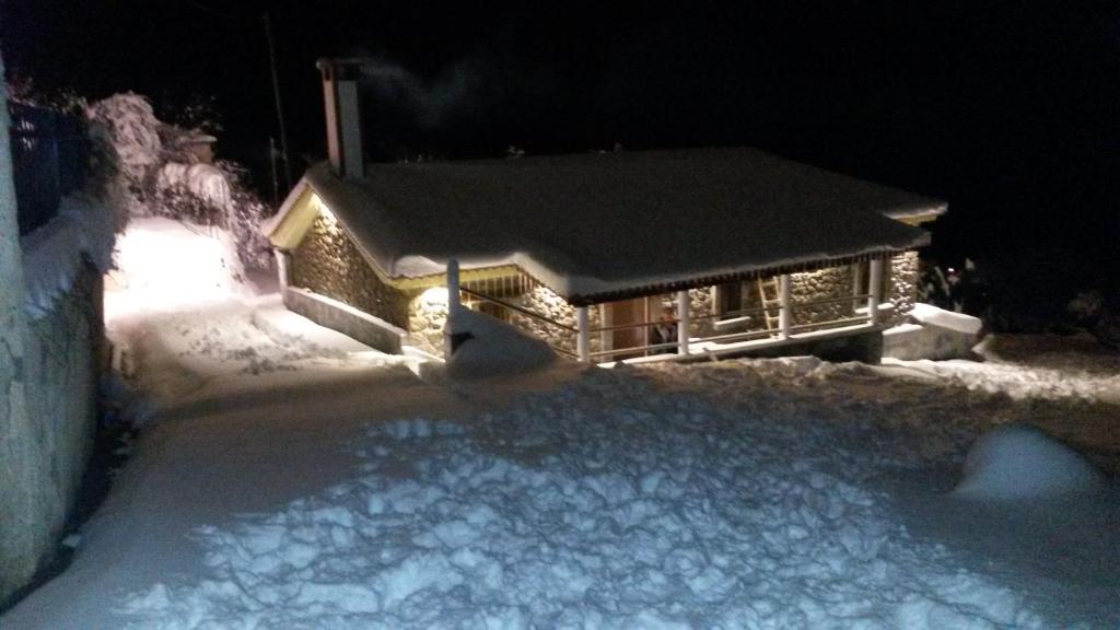 a cabin in the snow at night with snow at Litheon House in Synikia Mesi Trikalon