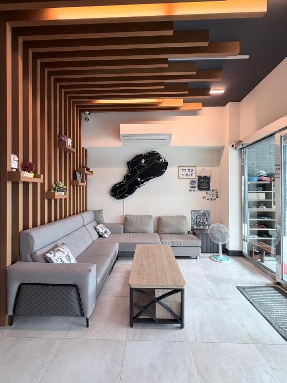 a living room with a couch and a table at 98Inn in Xiaoliuqiu