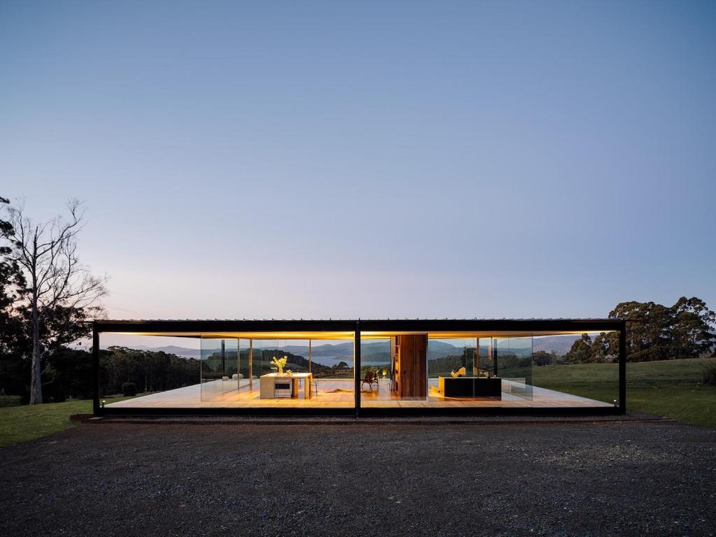 a large glass house with a large window at Triptych - The Glass House in Koonya