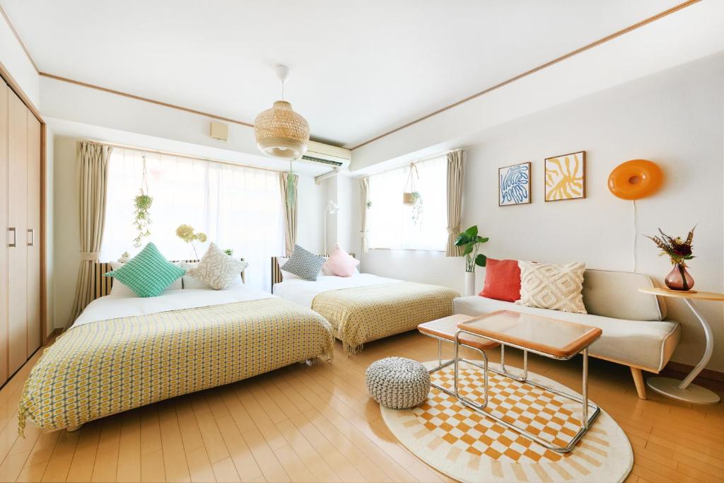 a living room with two couches and a table at Nagi Takamatsu 702 in Takamatsu