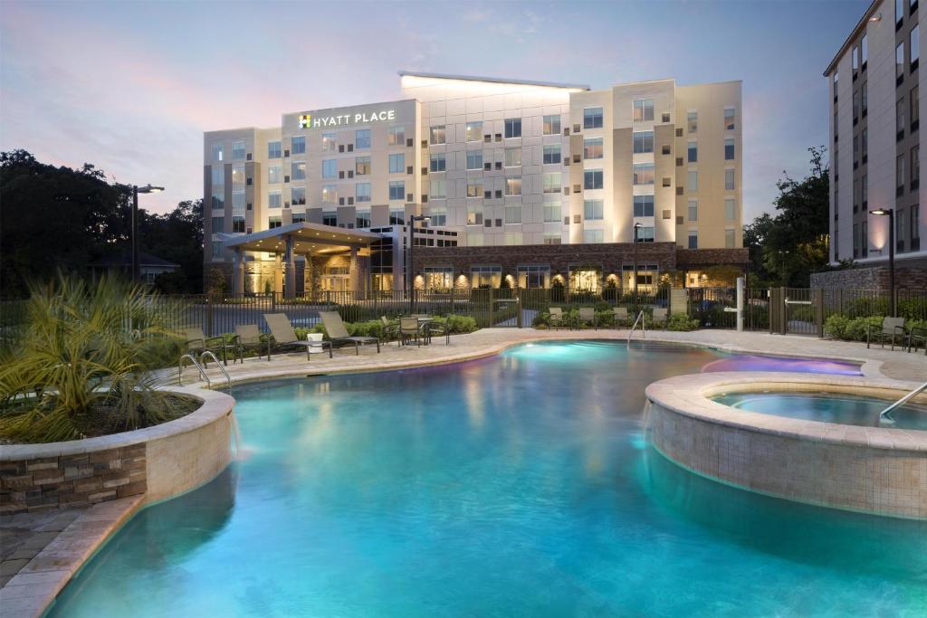 a large swimming pool in front of a hotel at Hyatt Place Biloxi in Biloxi
