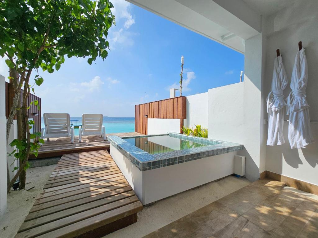 an outdoor pool with a view of the ocean at Lagoon View Maldives in Bodufolhudhoo