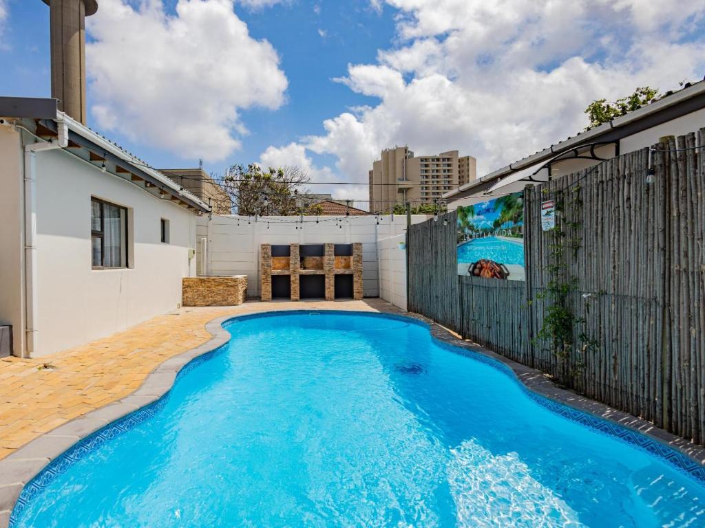 a swimming pool in the backyard of a house at La Bella Vida Self Catering Apartments in Bellville