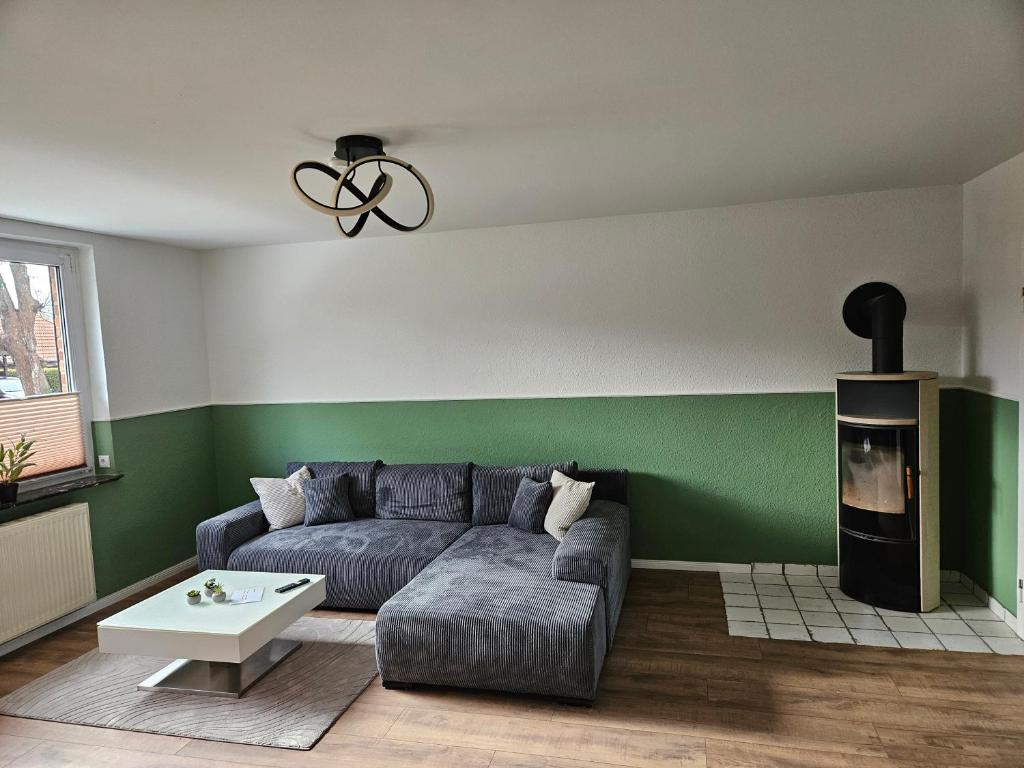 a living room with a couch and a fireplace at Fewo Kirch Jesar in Kirch Jesar