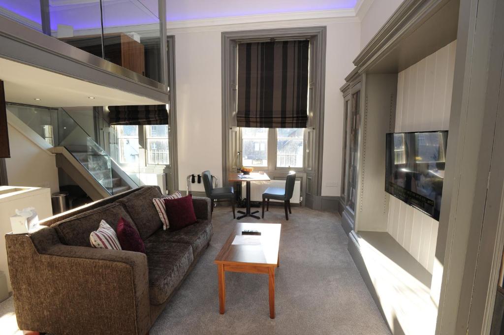 a living room with a couch and a table at Court Residence Aparthotel in Linlithgow