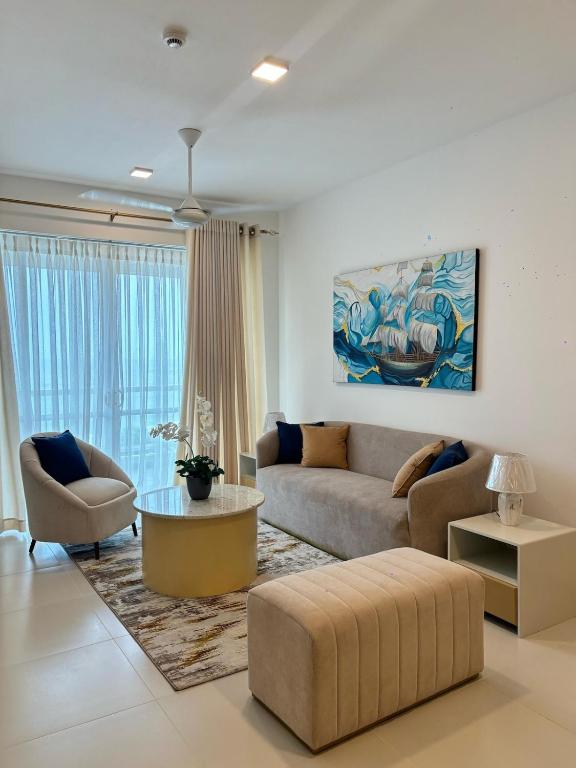 a living room with a couch and a table at Beach Front Escape in Wattala