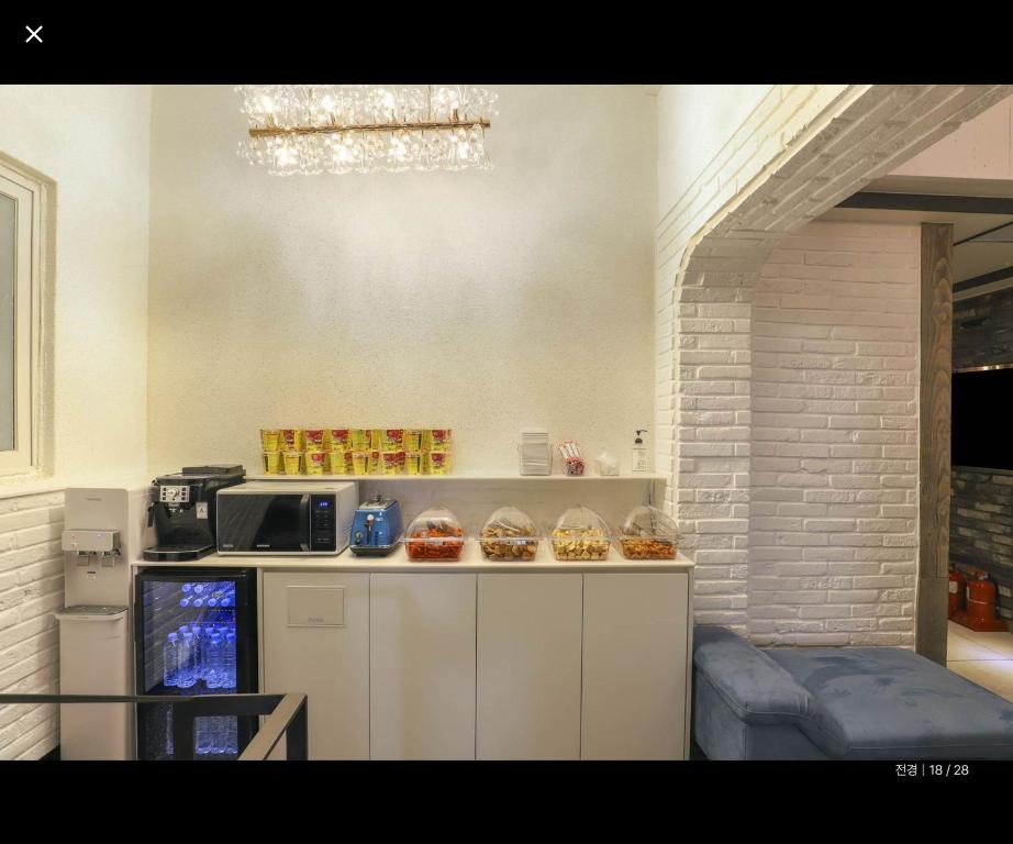 a kitchen with muffins on a counter with a microwave at 대구 더스테이낭만 태전점 in Daegu