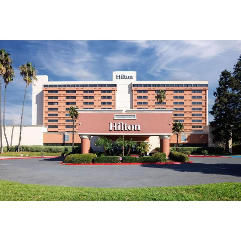 a hotel building with a sign in front of it at Hilton Concord in Concord