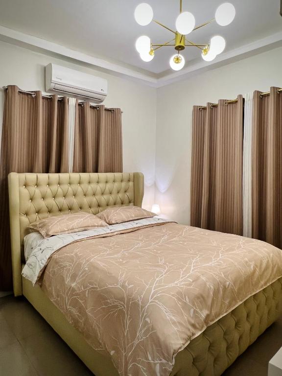 a bedroom with a bed and a ceiling fan at Serenity Stay in General Santos