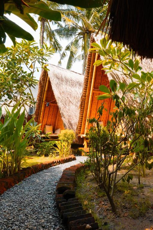 a building with a pathway in front of it at SAME SAME Bungalows by The Spot in Kuta Lombok