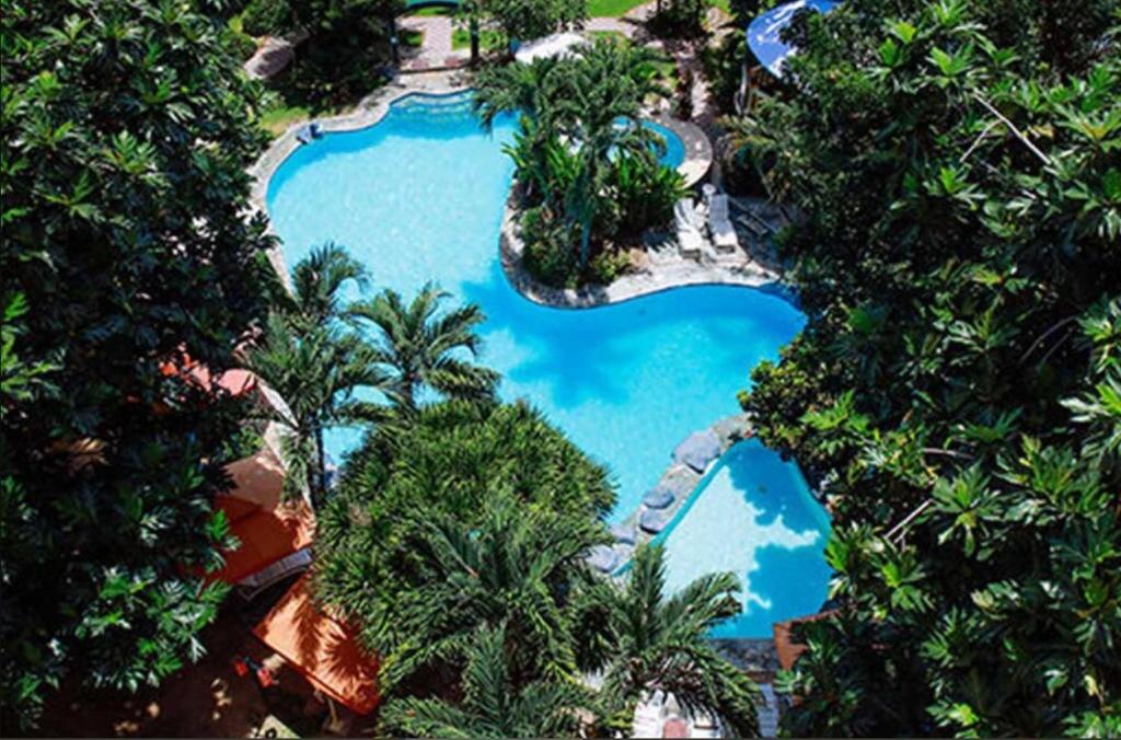 an overhead view of a swimming pool in a resort at Paradise Station 3 Garden Boracay Resort by JustGoFun in Boracay