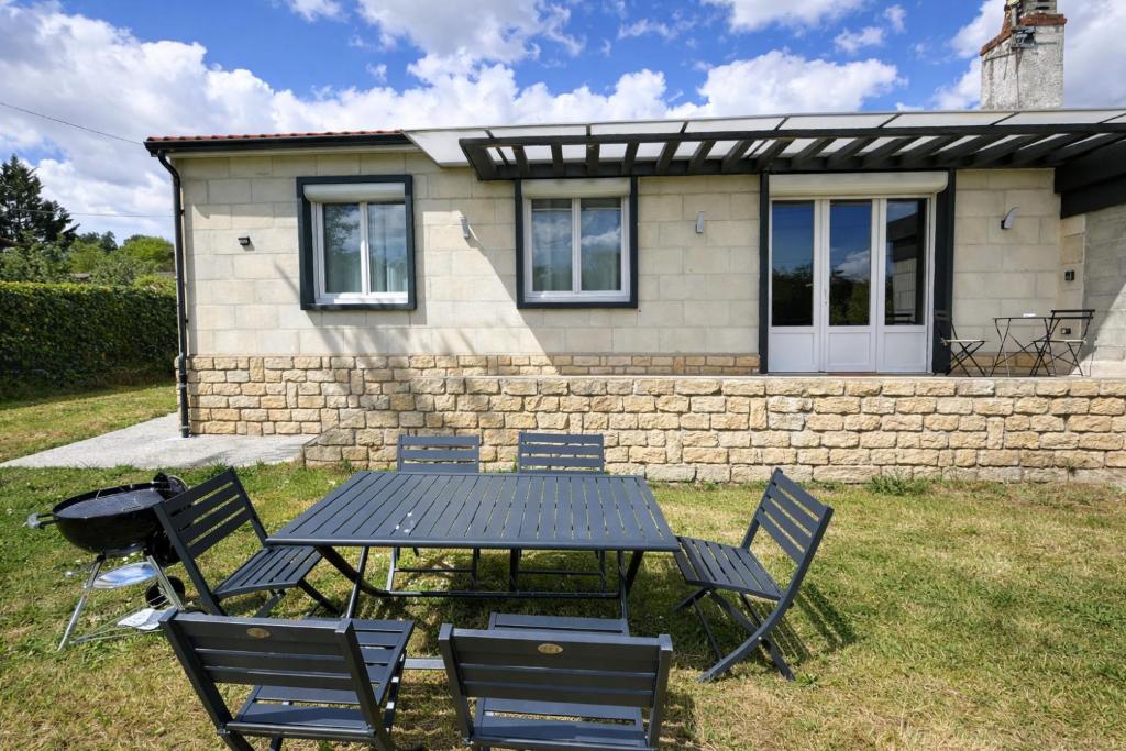 a picnic table and chairs in front of a house at Maison de vacances 6 personnes près de Bordeaux Green Escape in Cenon