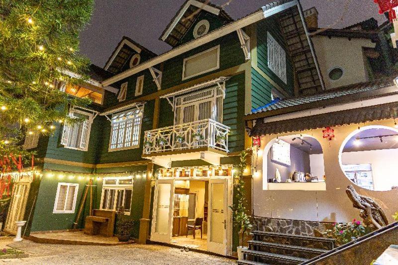 a large house with christmas lights on it at Olive Villa in Khu Chi Lăng