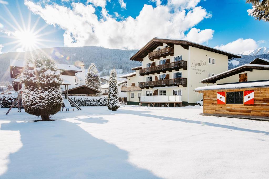 a hotel in the winter with snow on the ground at B&B Gästehaus Alpenblick in Lermoos