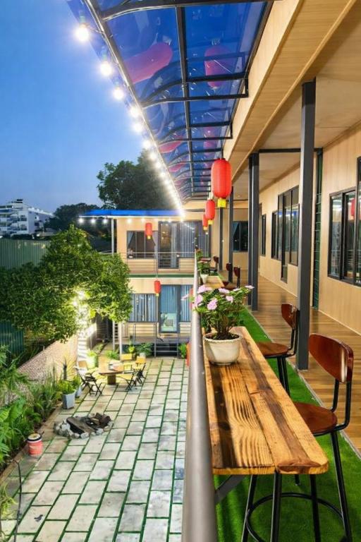 a patio with a wooden table and chairs at Đại Ngàn Homestay in Kon Von Kla