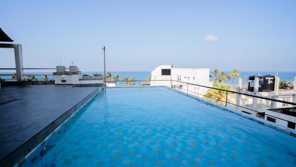 a swimming pool on the roof of a building at Crystal Sand Mount Lavinia in Mount Lavinia