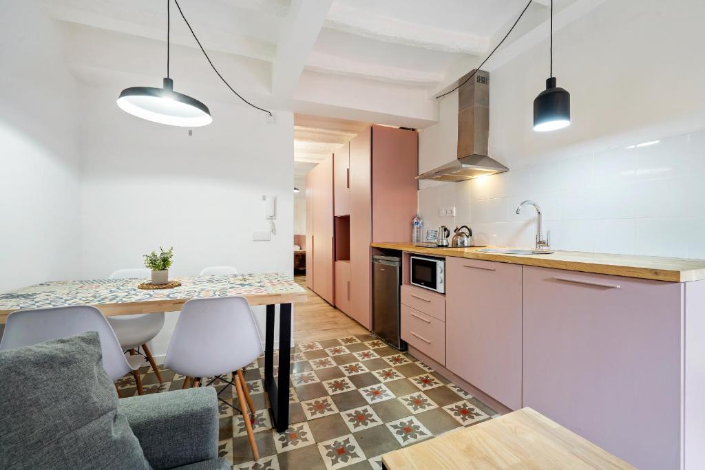 a kitchen with a counter and a table and chairs at FORUM EXPERIENCE Adults Only in Tarragona