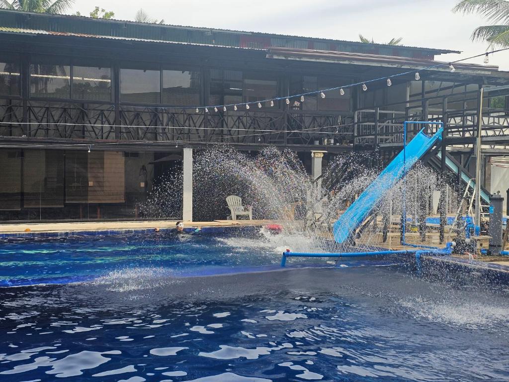 a water slide in the middle of a swimming pool at Island Sea One Resort in Panglao Island