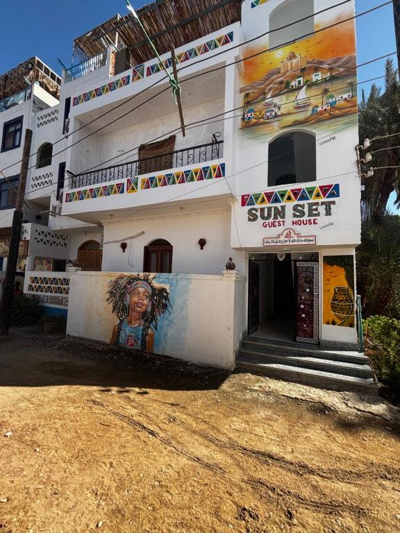 a building with a mural on the side of it at sunset guest house in Aswan