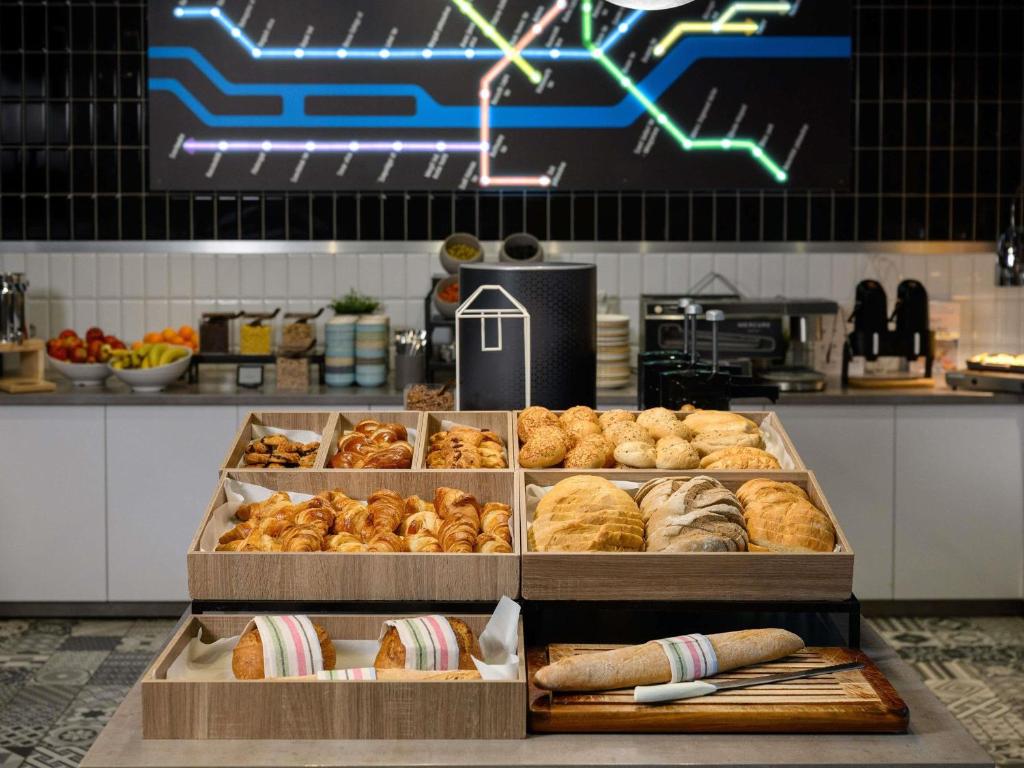 a bakery with several trays of bread and pastries at ibis Budapest Castle Hill in Budapest