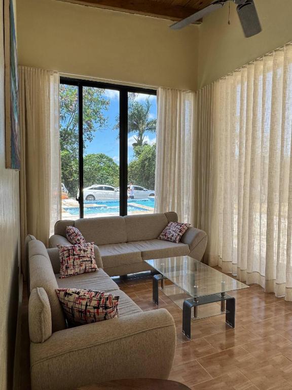 a living room with a couch and a glass table at Las Indgenas 6BR Pool Jacuzzi Gazebo in Imbert