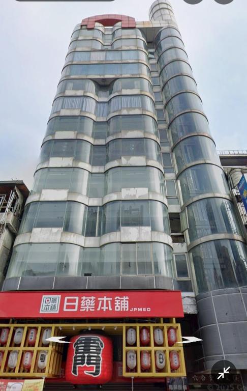 a tall building with a sign in front of it at Hao Chi Tao Hotel in Kaohsiung