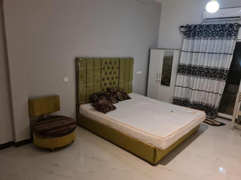 a bedroom with a bed and a chair at A & S residences in Pannipitiya
