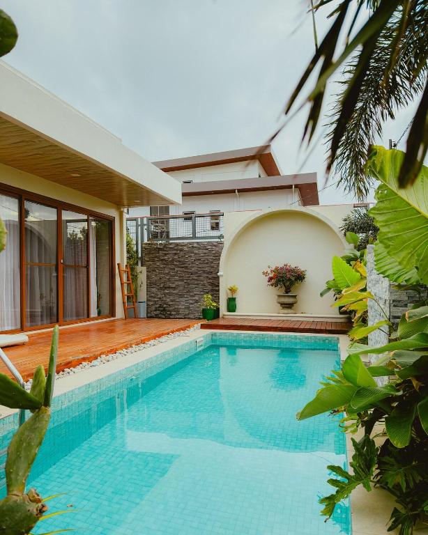 a swimming pool in front of a house at Villa Kaiyo La Union in Bacnotan
