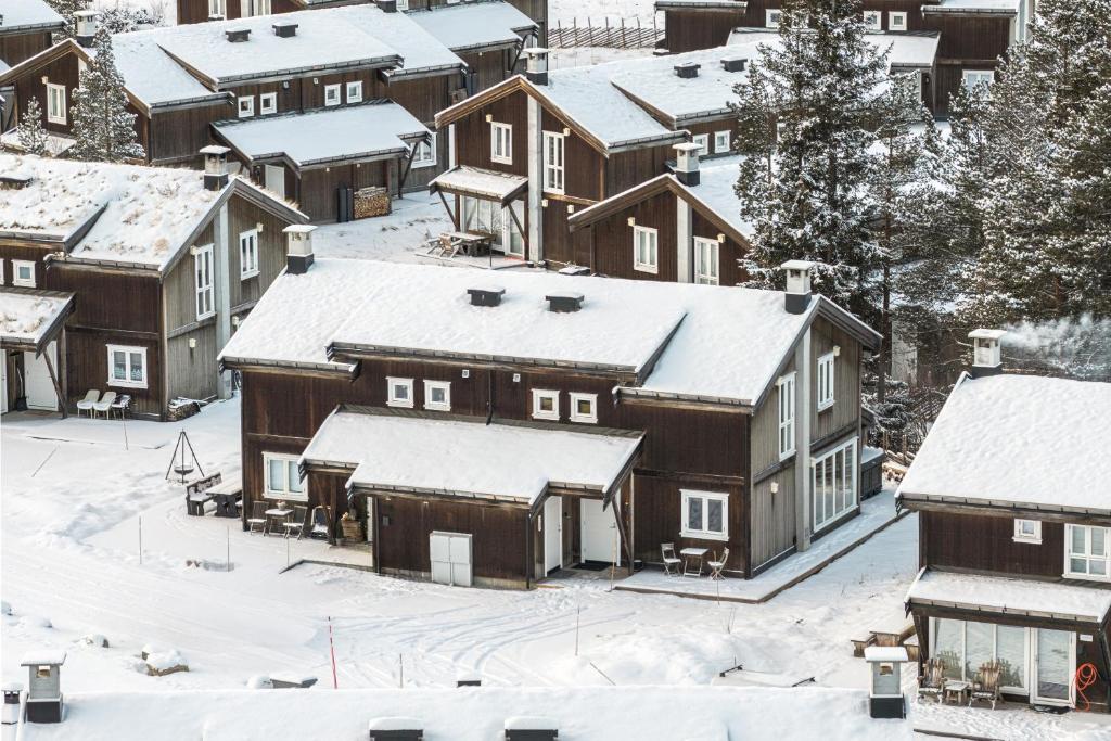 a group of houses with snow covered roofs at Harmony in Geilo, modern and cozy cabin in Geilo