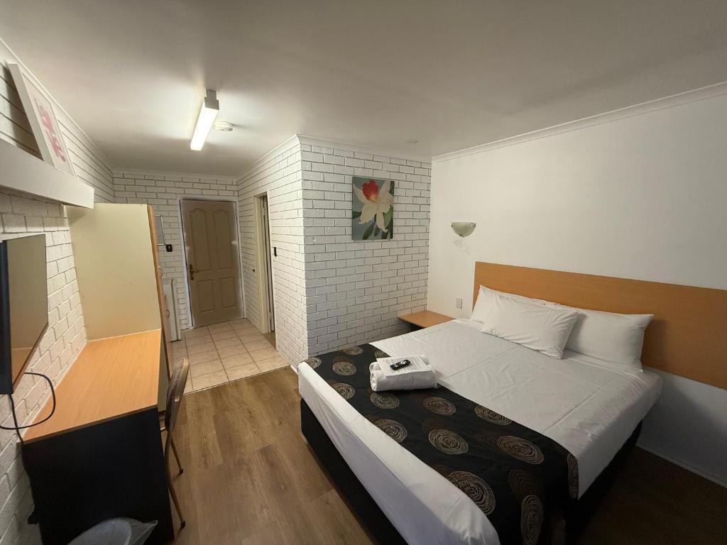 a bedroom with a large bed in a room at Budget Motel in Midland Junction