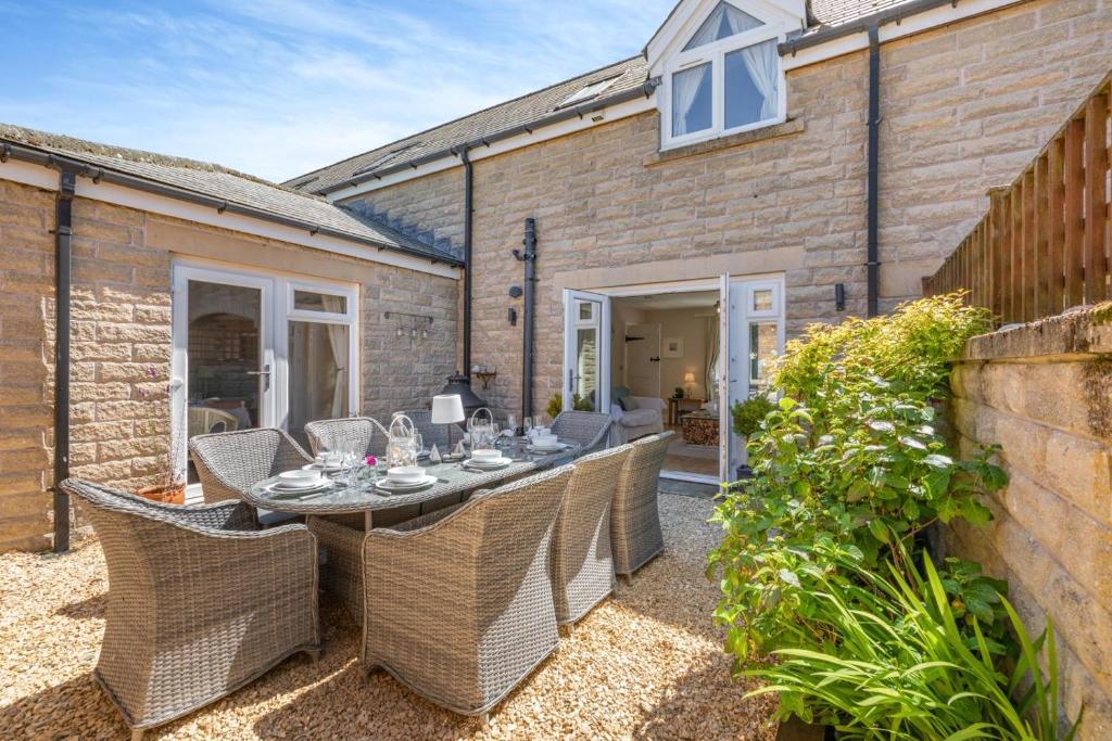 a patio with a table and chairs in a yard at 3 Bed in Beadnell oc-44965 in Beadnell