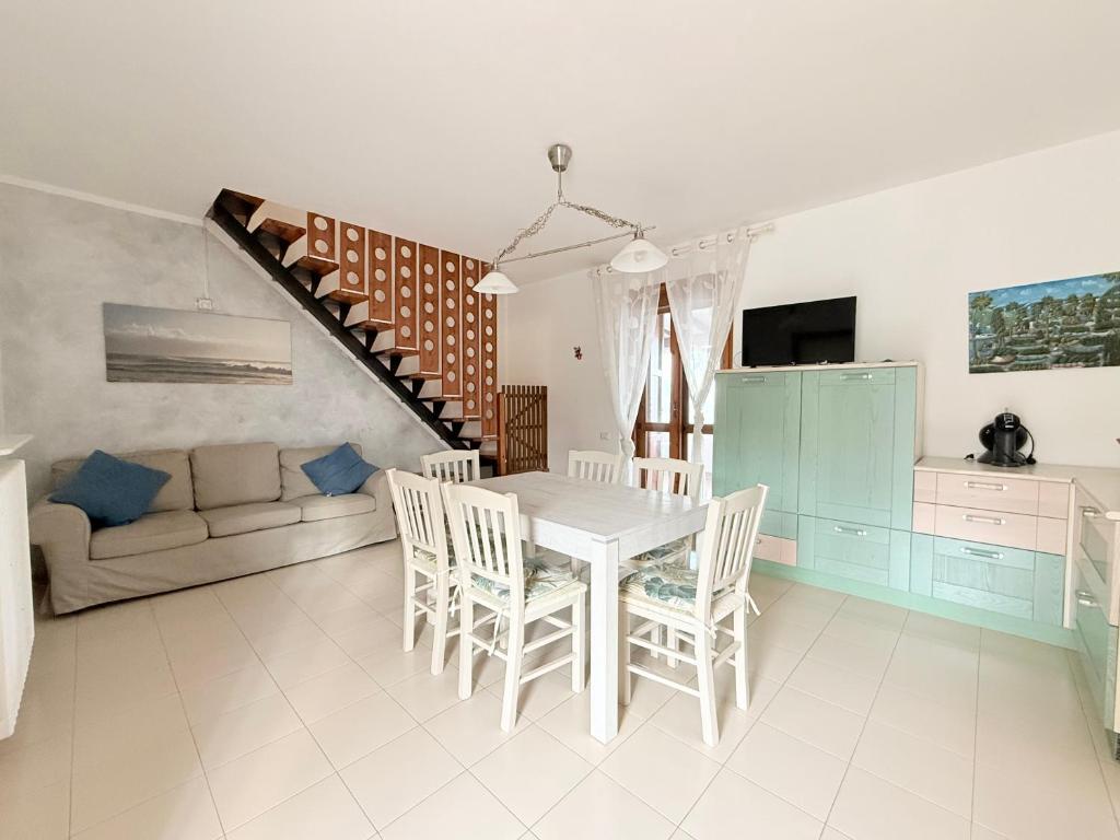 a kitchen and dining room with a table and chairs at M274 - Marcelli, comodo quadrilocale vista mare con terrazzo in Marcelli