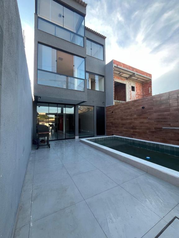 a large house with a swimming pool in front of it at Espaço Viva Guarujá in Guarujá