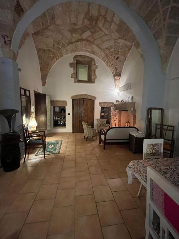 a living room with a large room with a stone ceiling at Zen Palazzo Storico in Alliste