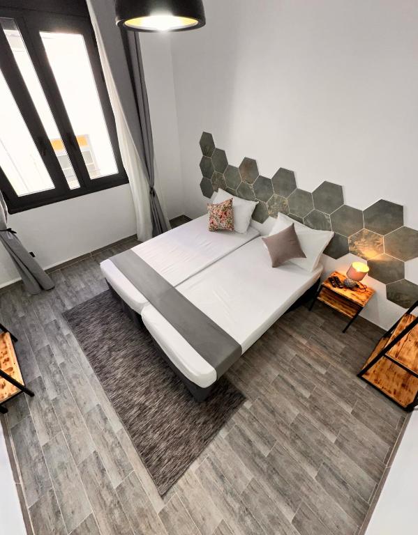 a bedroom with a large bed and a large window at Dar el bahdja in Sidi MʼHamed