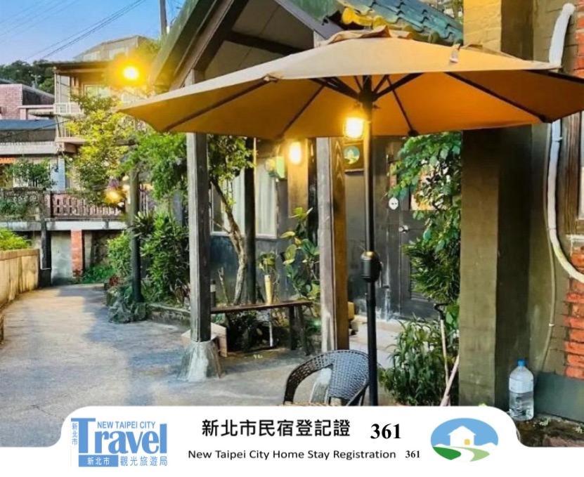 an umbrella sitting in front of a building at Jiuju in Jiufen