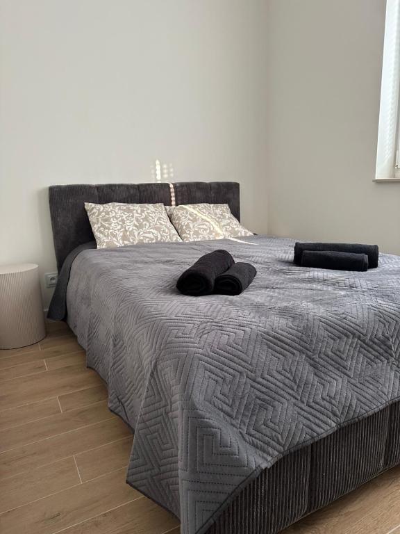 a bedroom with a bed with two towels on it at Brzostek Apartamenty in Marki