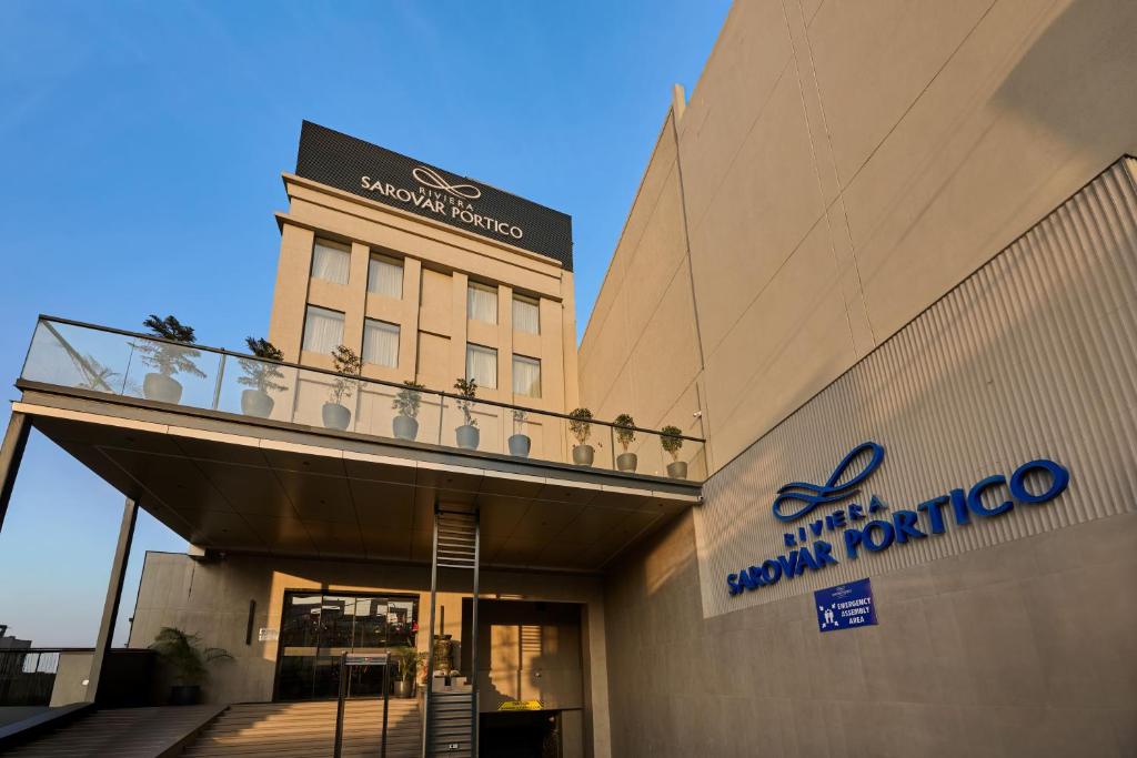a building with a sign on the side of it at Riviera Sarovar Portico Pathankot in Pathānkot