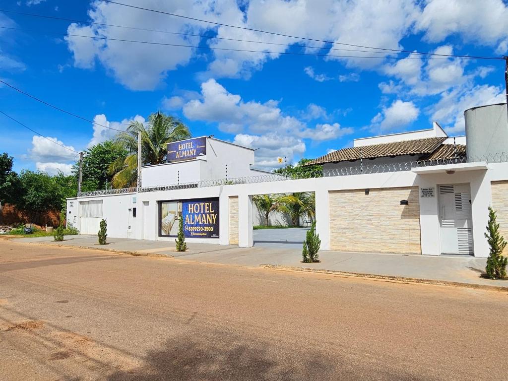 a white building on the side of a street at Hotel Almany in Palmas
