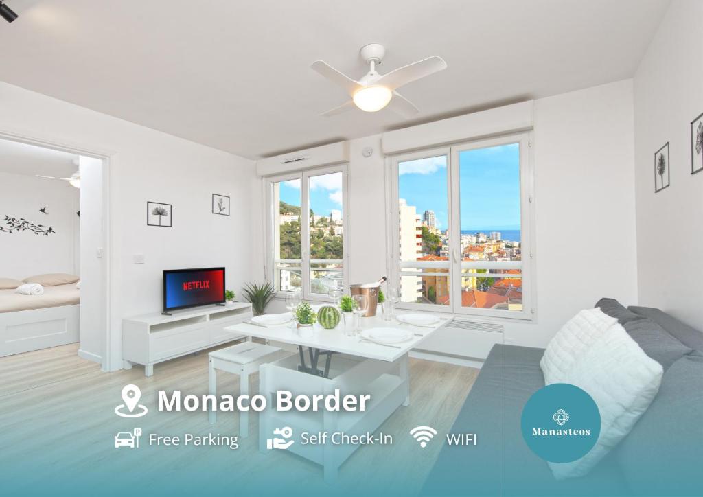 a white living room with a couch and a tv at Haut de Monaco - Vue panoramique mer et ville - FE in Beausoleil