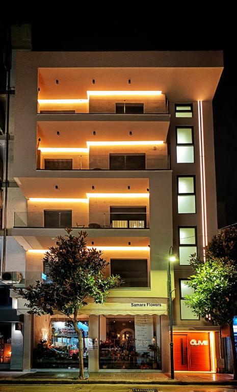 a large building with lights on the side of it at Olive City Suites in Larisa