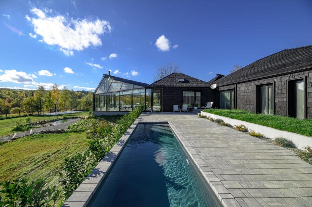 a swimming pool in the backyard of a house at Evergreen Retreat in Râșca